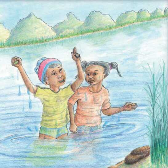 Two girls standing in a river, one girl with her hands up.