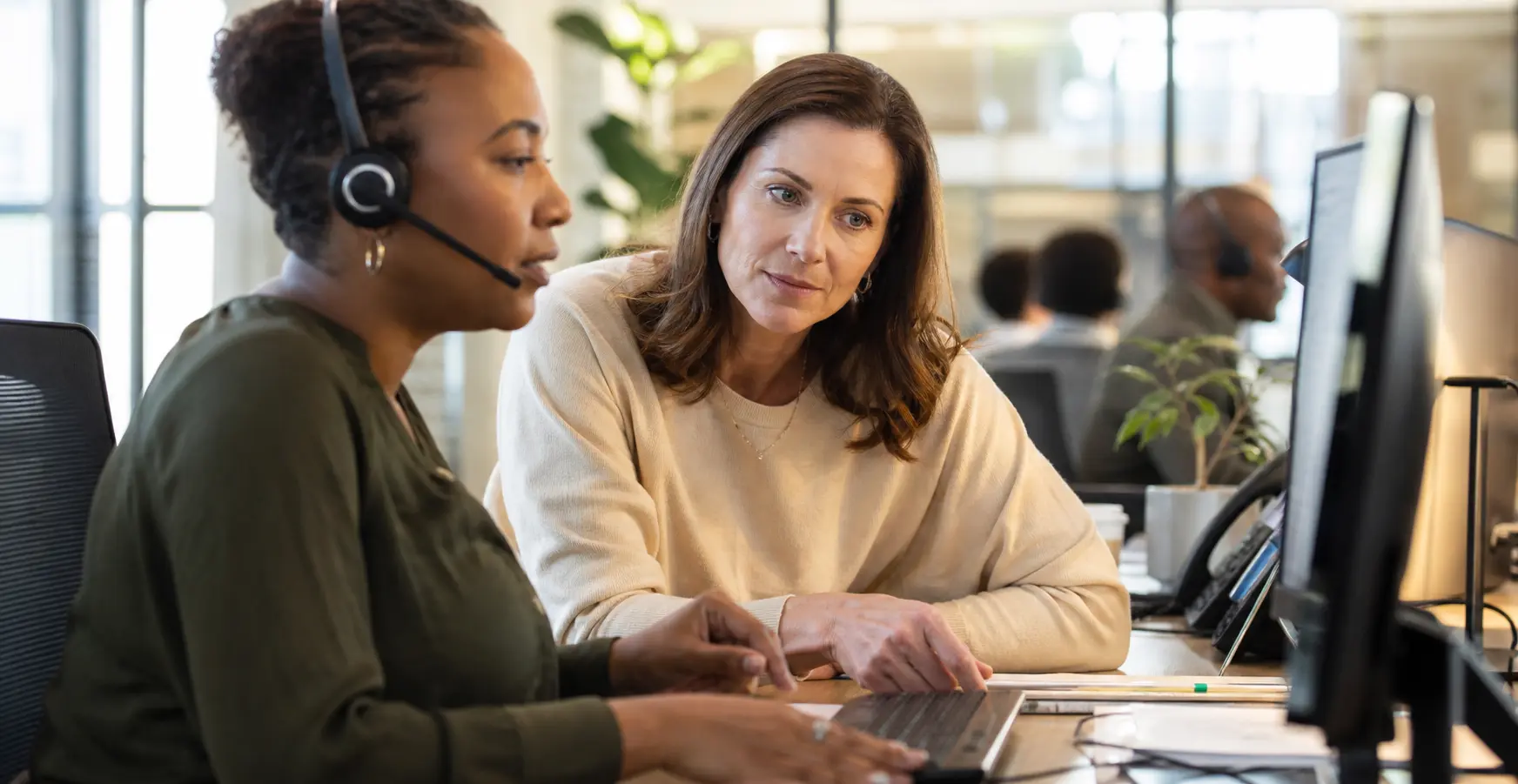 A support specialist and supervisor review a complex caller case before a human escalation.