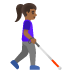 woman with white cane facing right: medium-dark skin tone emoji on Google