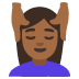 woman getting massage: medium-dark skin tone emoji on Google