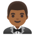 man in tuxedo: medium-dark skin tone emoji on Google