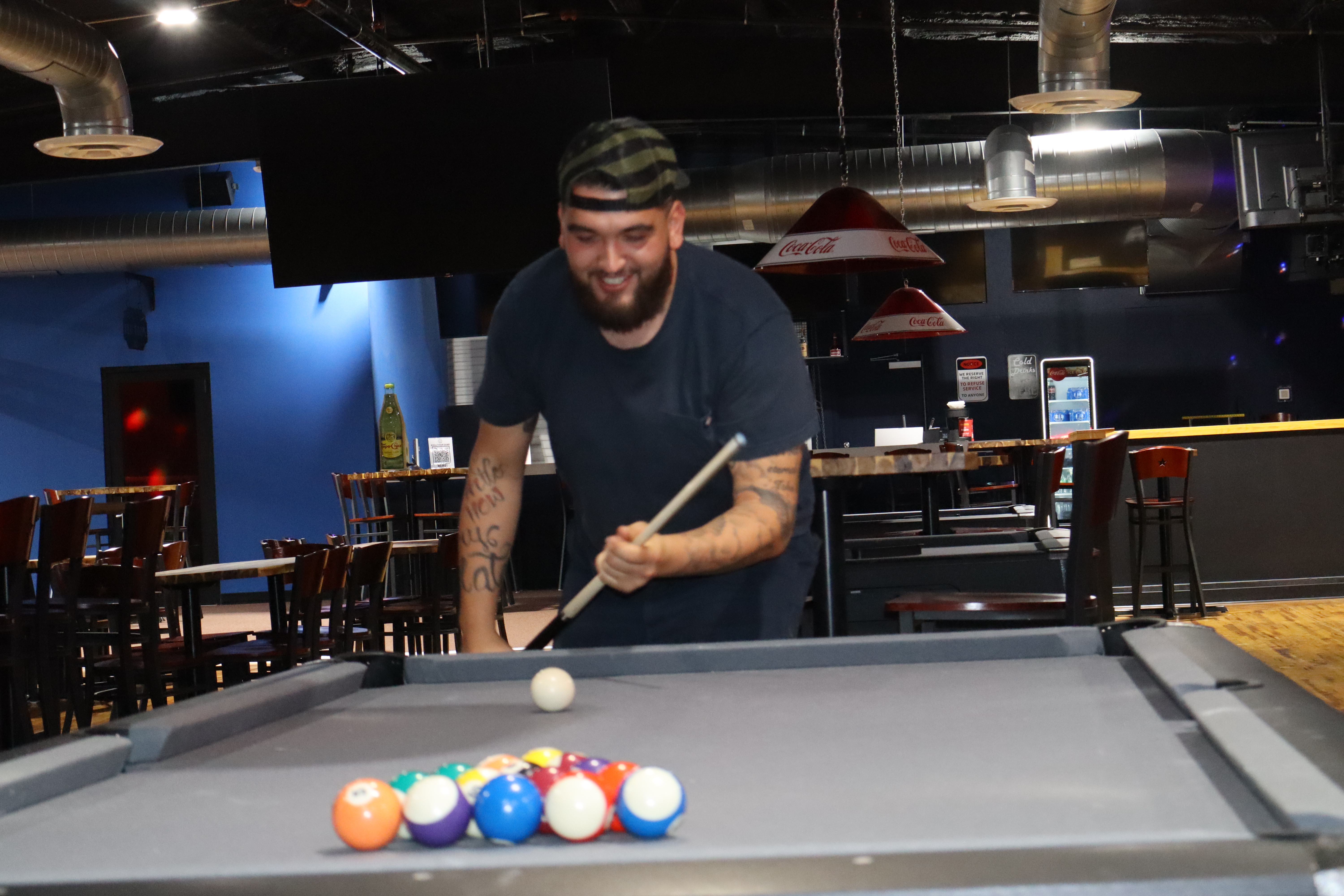 Player breaking at PBR pool table