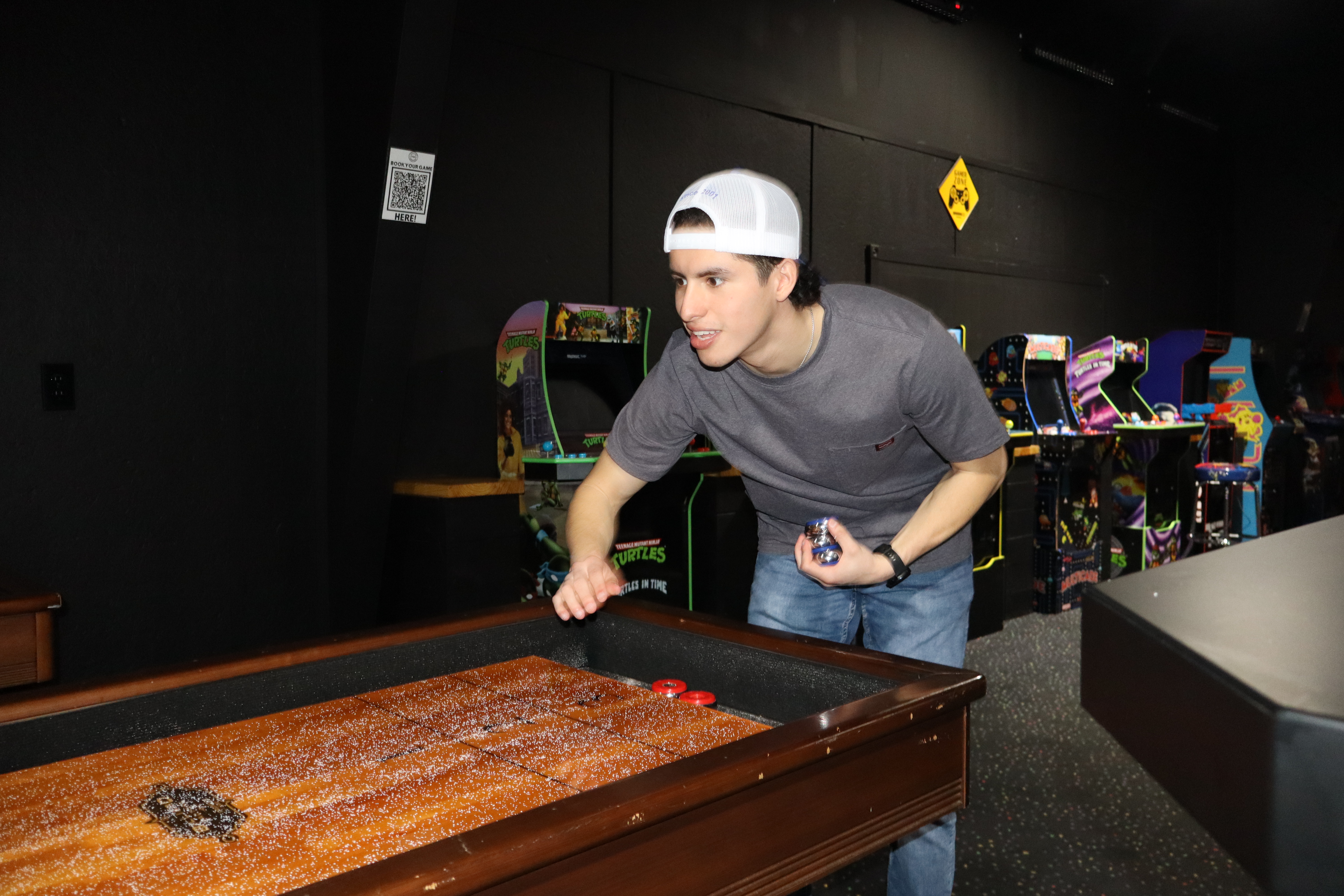 Player at shuffleboard table at PBR