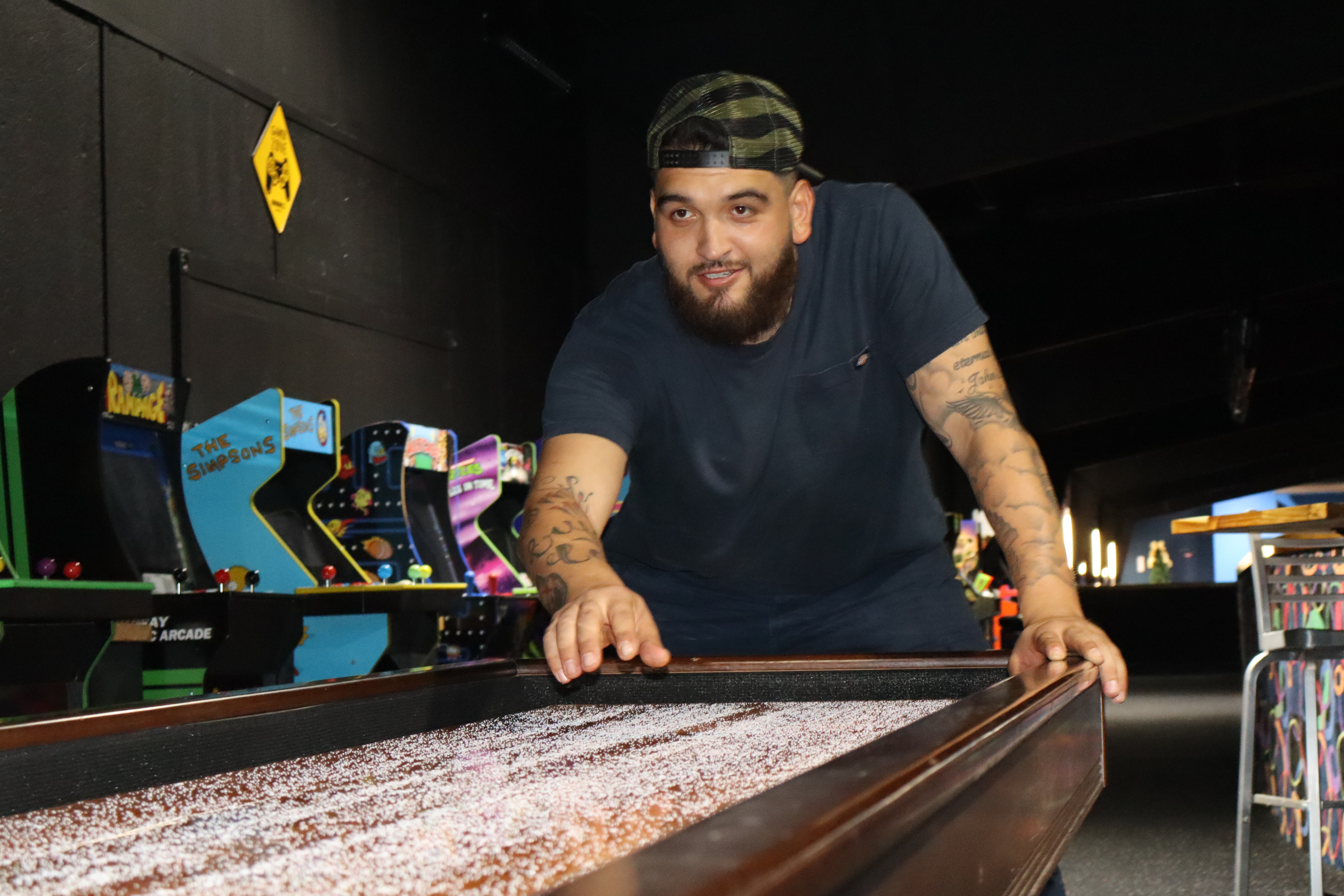 Shuffleboard at PBR with arcade in background