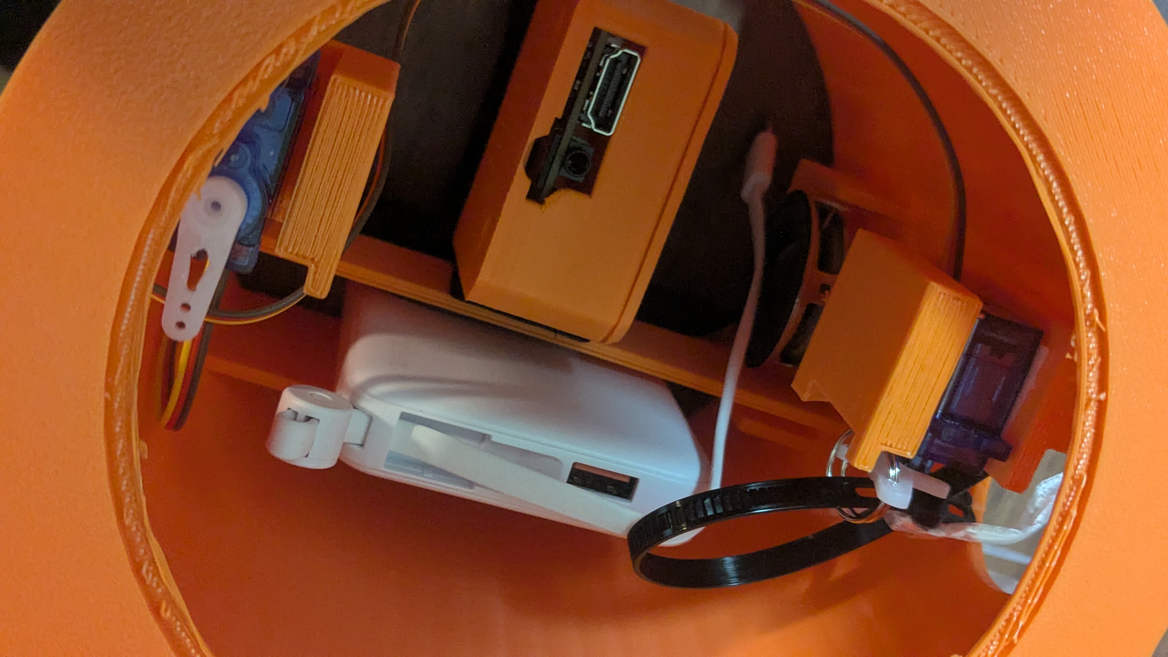Inside the torso — RDK X5, power bank, SG90 arm servos and speaker packed in