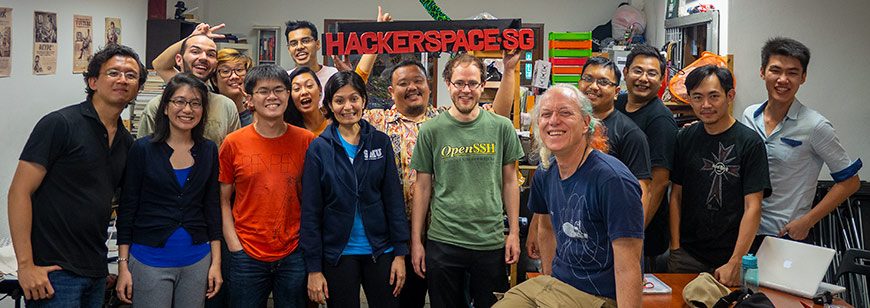 Group photo with a HackerspaceSG logo and Mitch Altman in December 2014