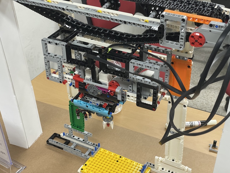 This is a picture of a sewer cleaning robot. At the top is a conveyor belt with the robot hanging from it.