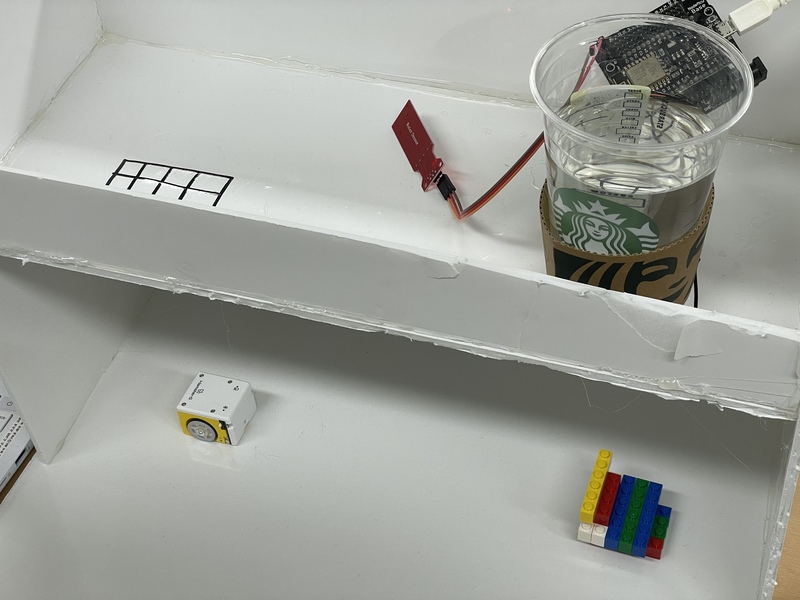 There is a water level sensor on top of the sewer model and a small bot waiting below the sewer mock-up.