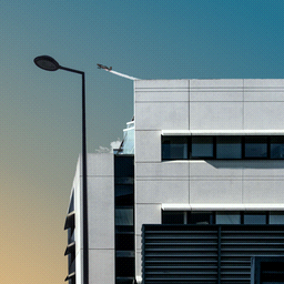 A building with a dithered gradient of the sky behind it.  A jet airplane is taking off in the sky.