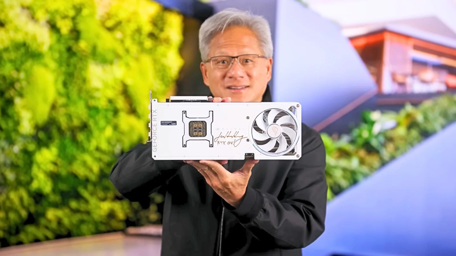 Jensen Huang holding an autographed 30th Anniversary Asus ROG Astra RTX 5090 White OC