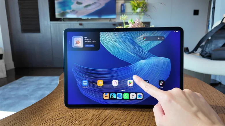 A finger pointing at the Play Store icon on an Amazon Alexa Tablet 12 Pro.