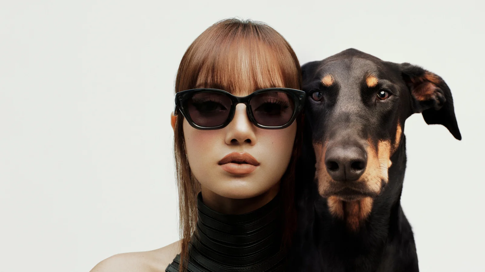 LISA wearing the Meta Capri LISA Edition glasses next to her dog.
