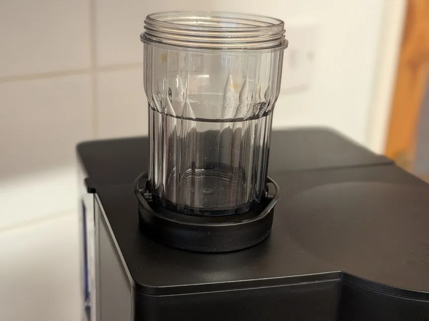 The concentrate cup is small and cheap, but has a secure lid.