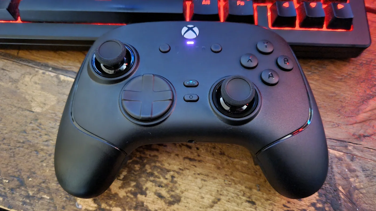 A Razer Wolverine V4 Pro gaming controller shot from above on a desk, below a gaming keyboard