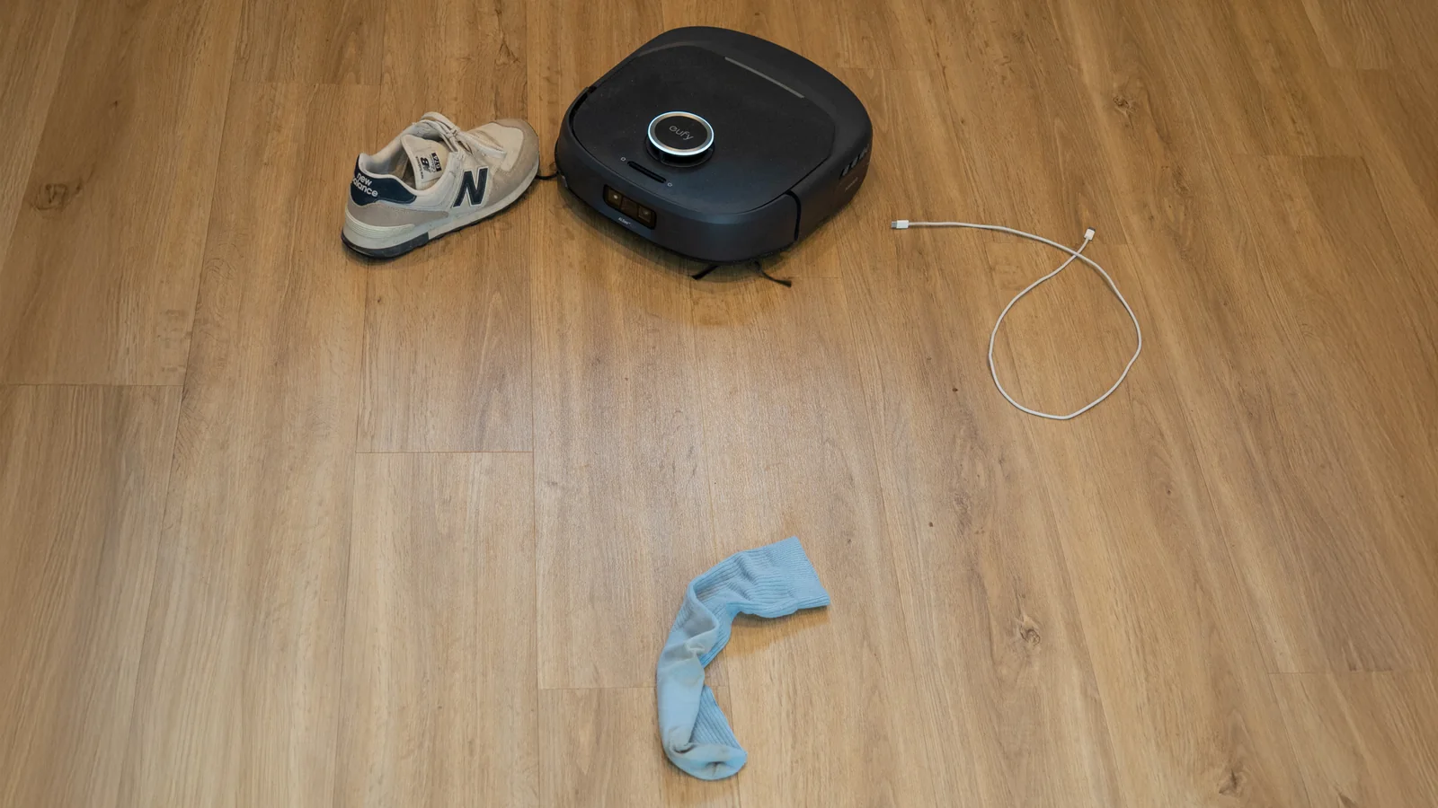 Eufy Omni E35 robot vacuum navigating around obstacles on a floor