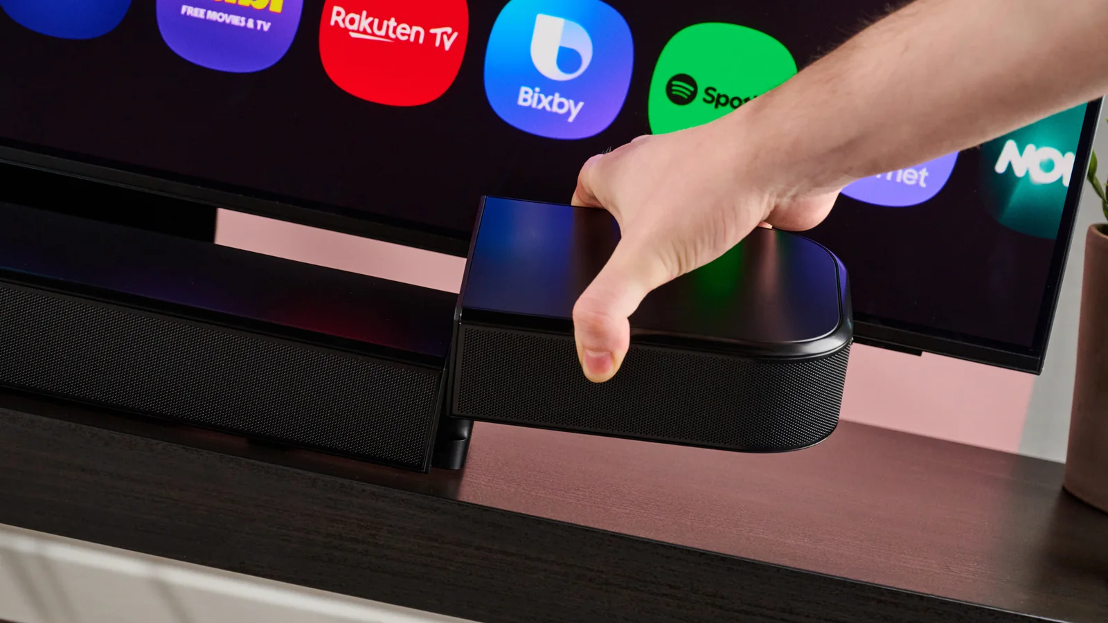 Man attaching surround speaker to the JBL Bar 800MK2