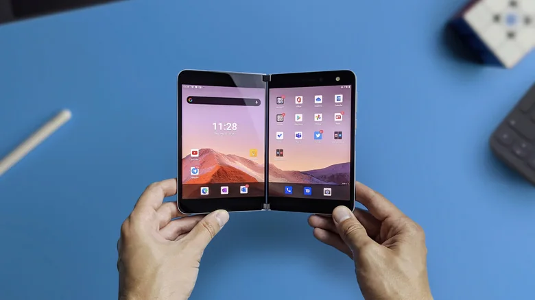 Two hands holding the Microsoft Surface Duo.