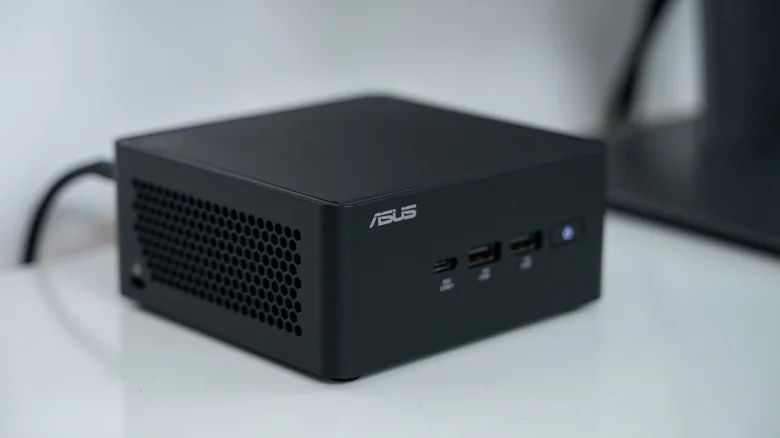 ASUS NUC mini PC on a white desk.