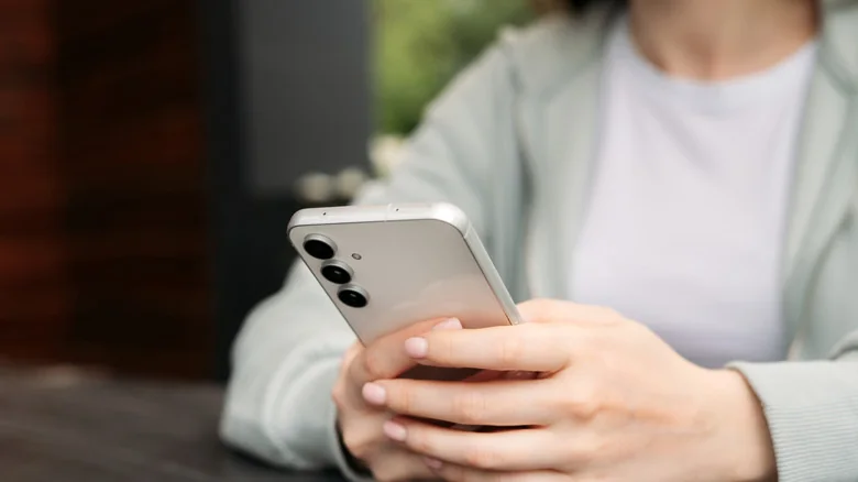 Samsung phone held in two hands, portrait.