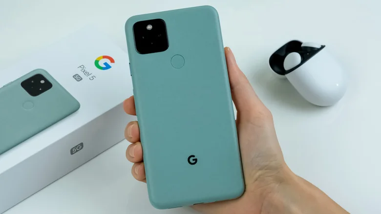 Google Pixel 5 in Sorta Sage color, alongside pixel buds.