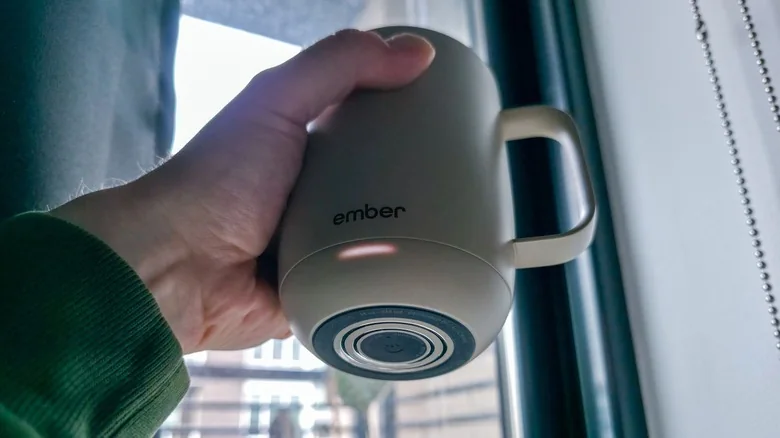 Bottom view of Ember Mug 3 shows power button and charging contact on base.