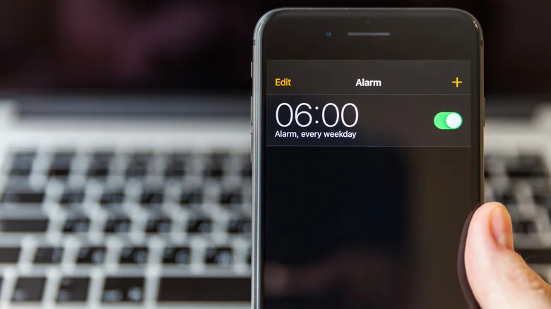 An iPhone screen, displaying an alarm set for 6 AM every weekday.