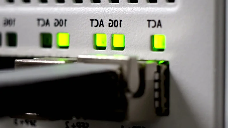 Network cable connected to a port with green activity lights.