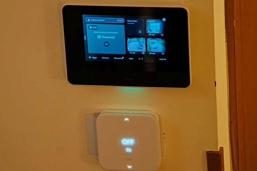 Vivint security panel and sensor on wall.