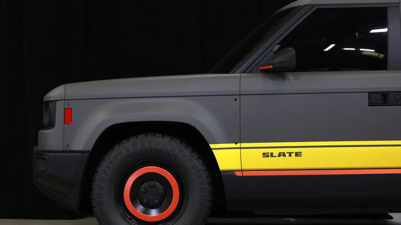 A gray Slate truck with stylized rims and body panels against a black background.