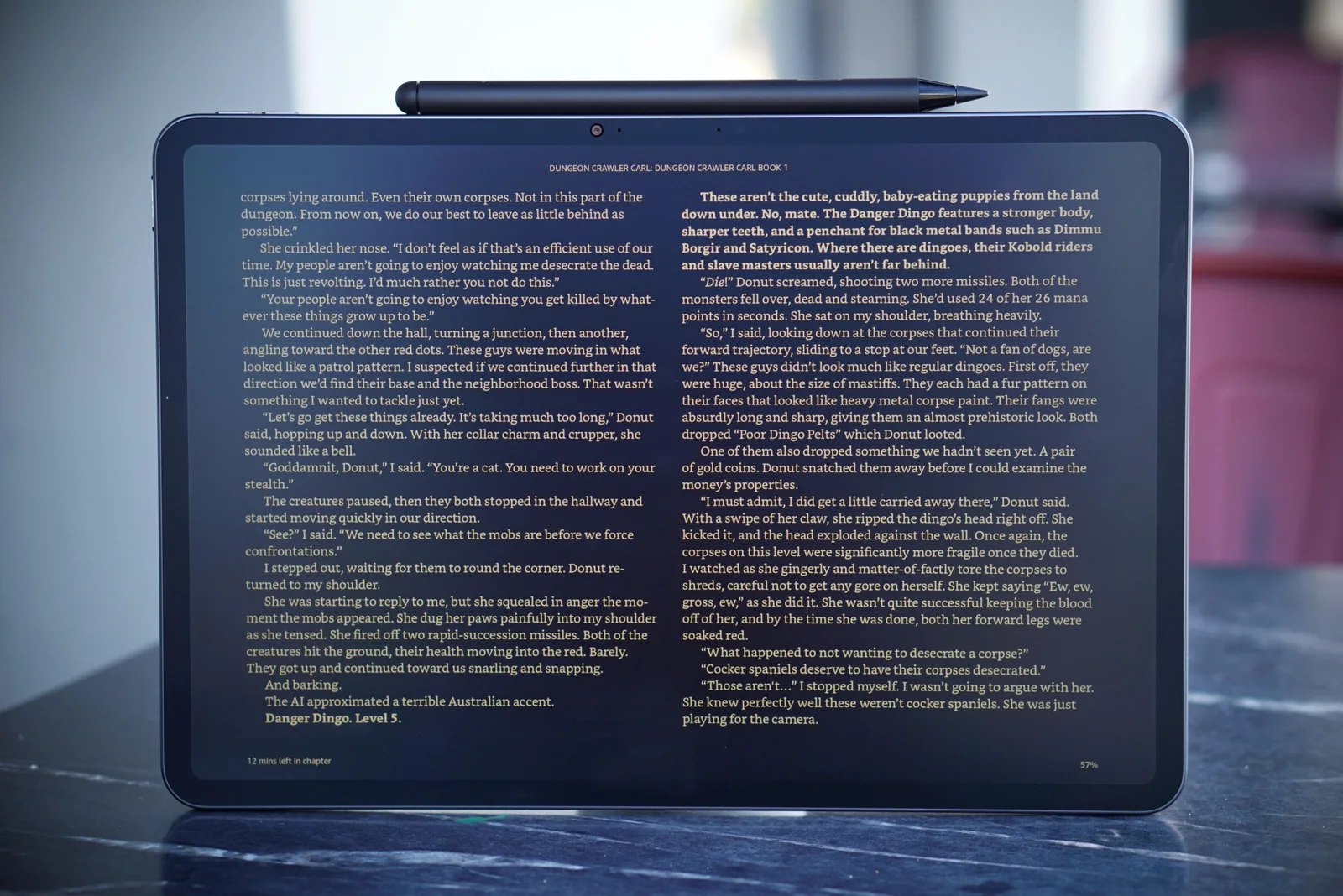 An Alexa Tablet propped up on a table, showing a page from a book.