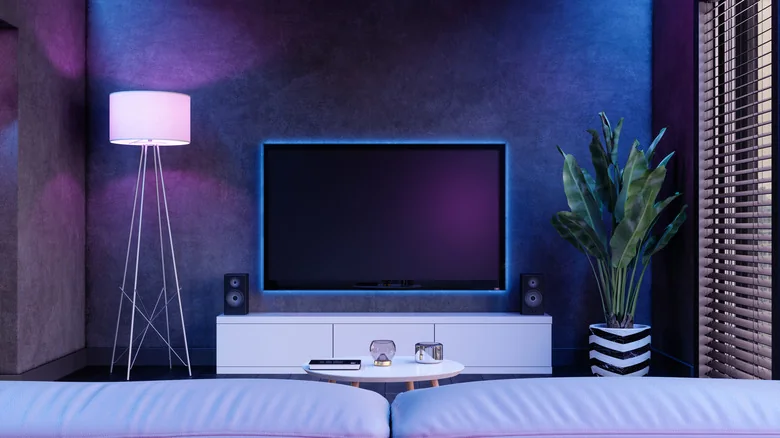 A modern living room and TV with fancy lighting.