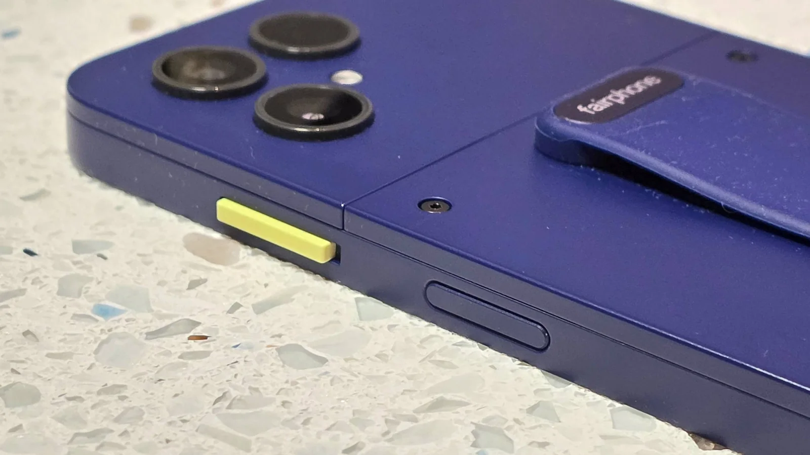 The Fairphone 6 Plus on a table, showing the side switch.