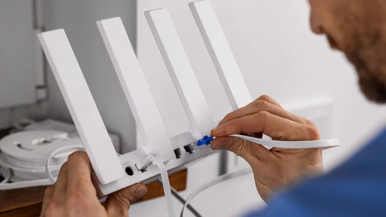 Service technician working on a Wi-Fi router.