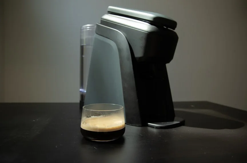 tabli coffee machine with brewed espresso next to it