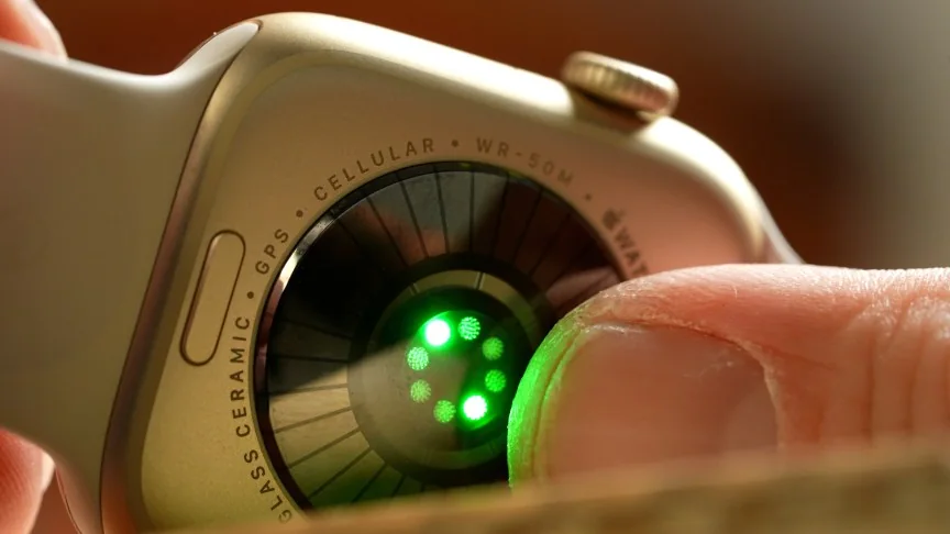closeup of rear of Apple Watch showing green sensor lights