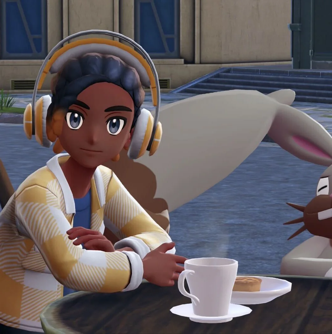 A Pokémon Legends: Z-A screenshot depicting a trainer and a Diggersby sitting at a table in front of a cafe.
