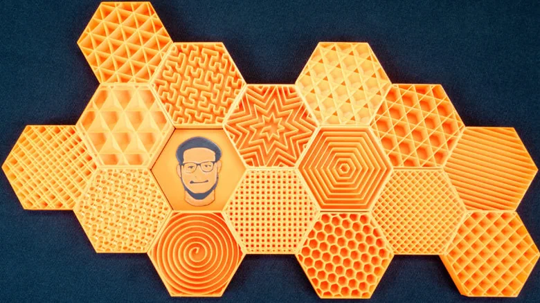 Orange 3D-printed hexagonal samples displaying different infill patterns.