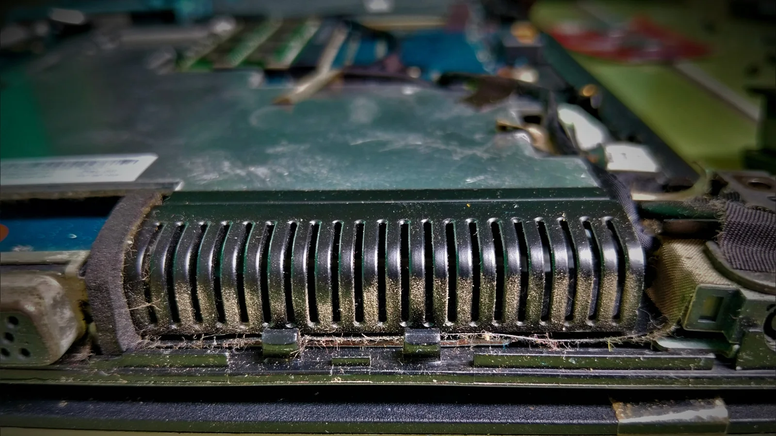 Dust built up on the heat-sink fins inside a laptop.