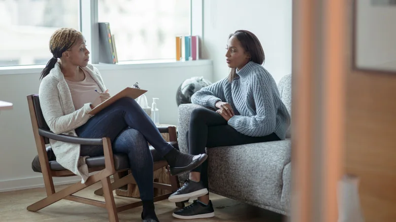 Woman talking with her therapist in an office.