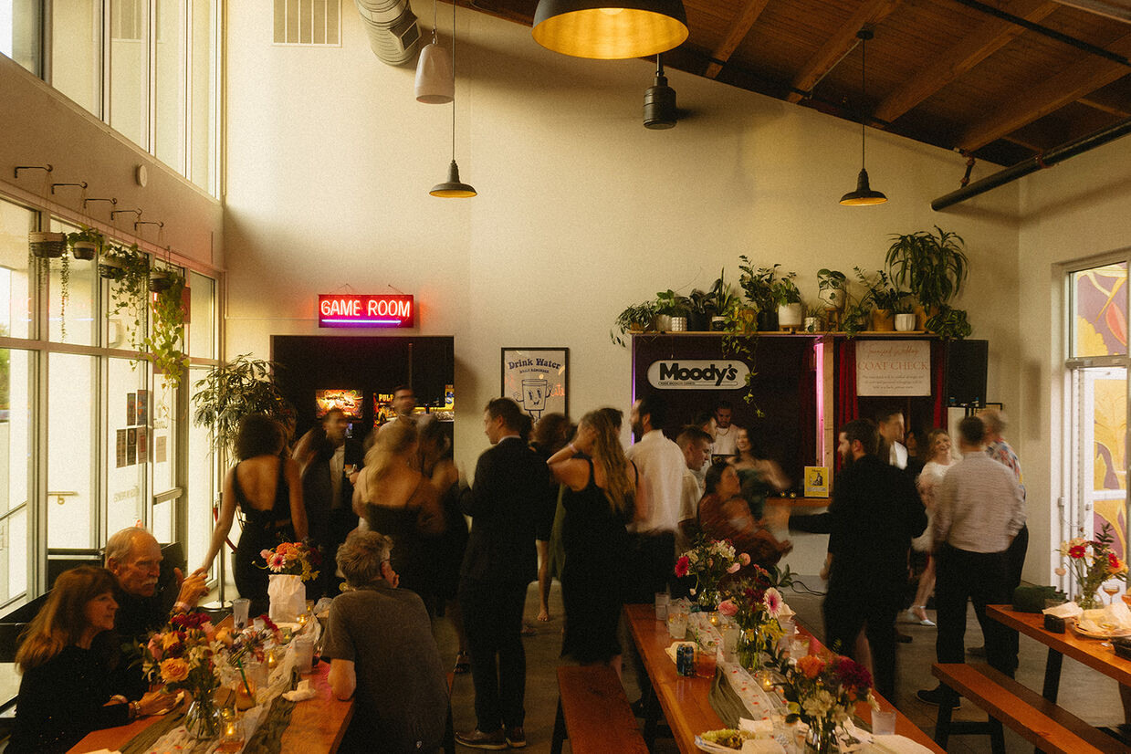 Food cart pod wedding reception venue with coat check station visible