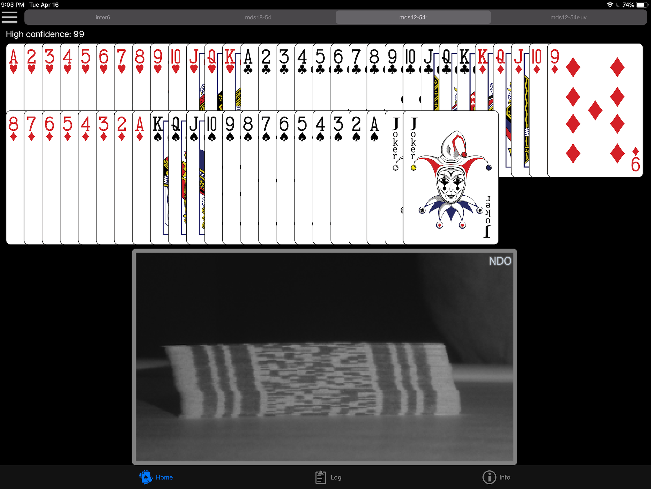 A screenshot of an app containing an array of playing cards in suit and numerical order, with a black-and-white image of a deck of playing cards with edge-marks clearly visible.