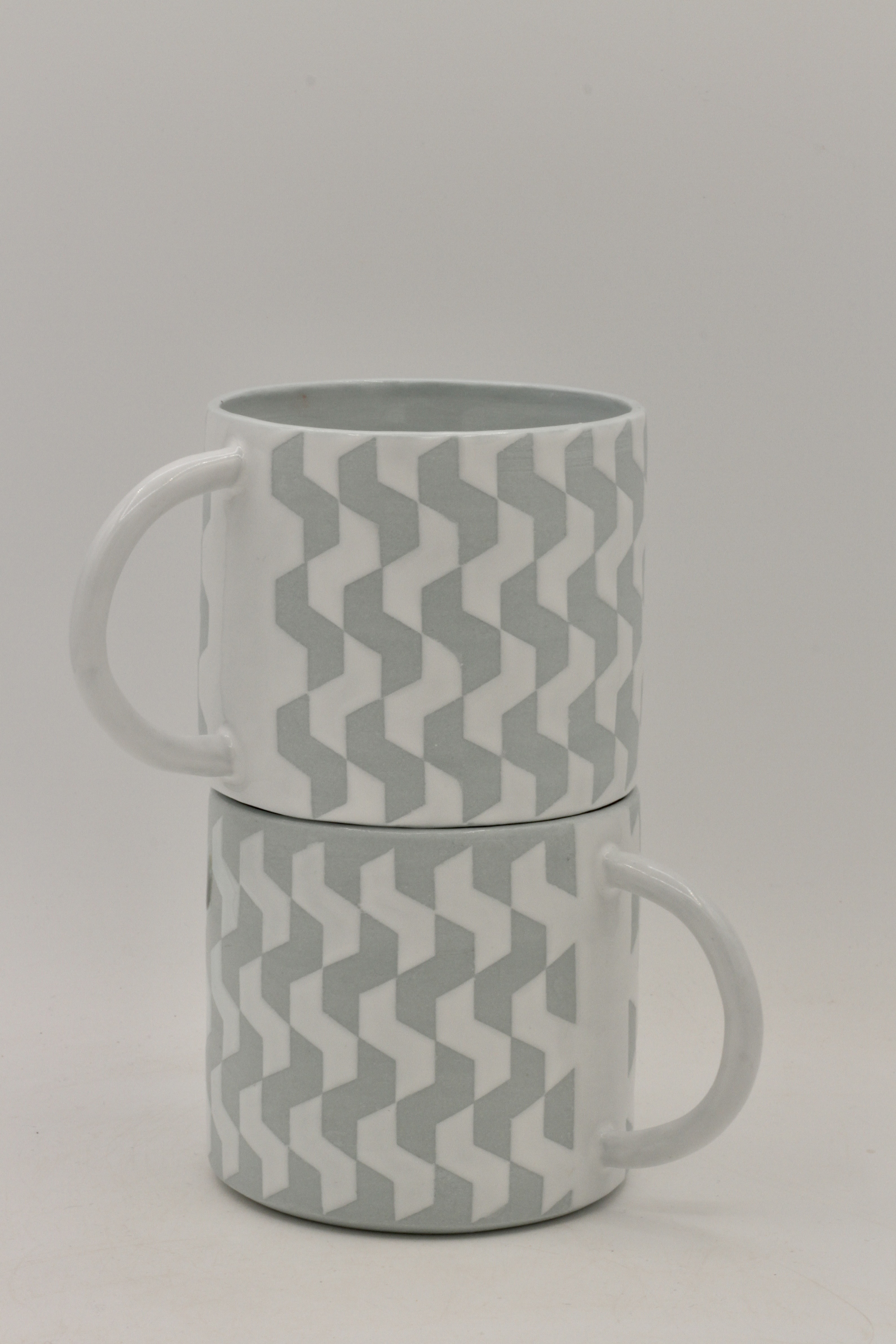 twin porcelain blue-grey and white patterned mugs