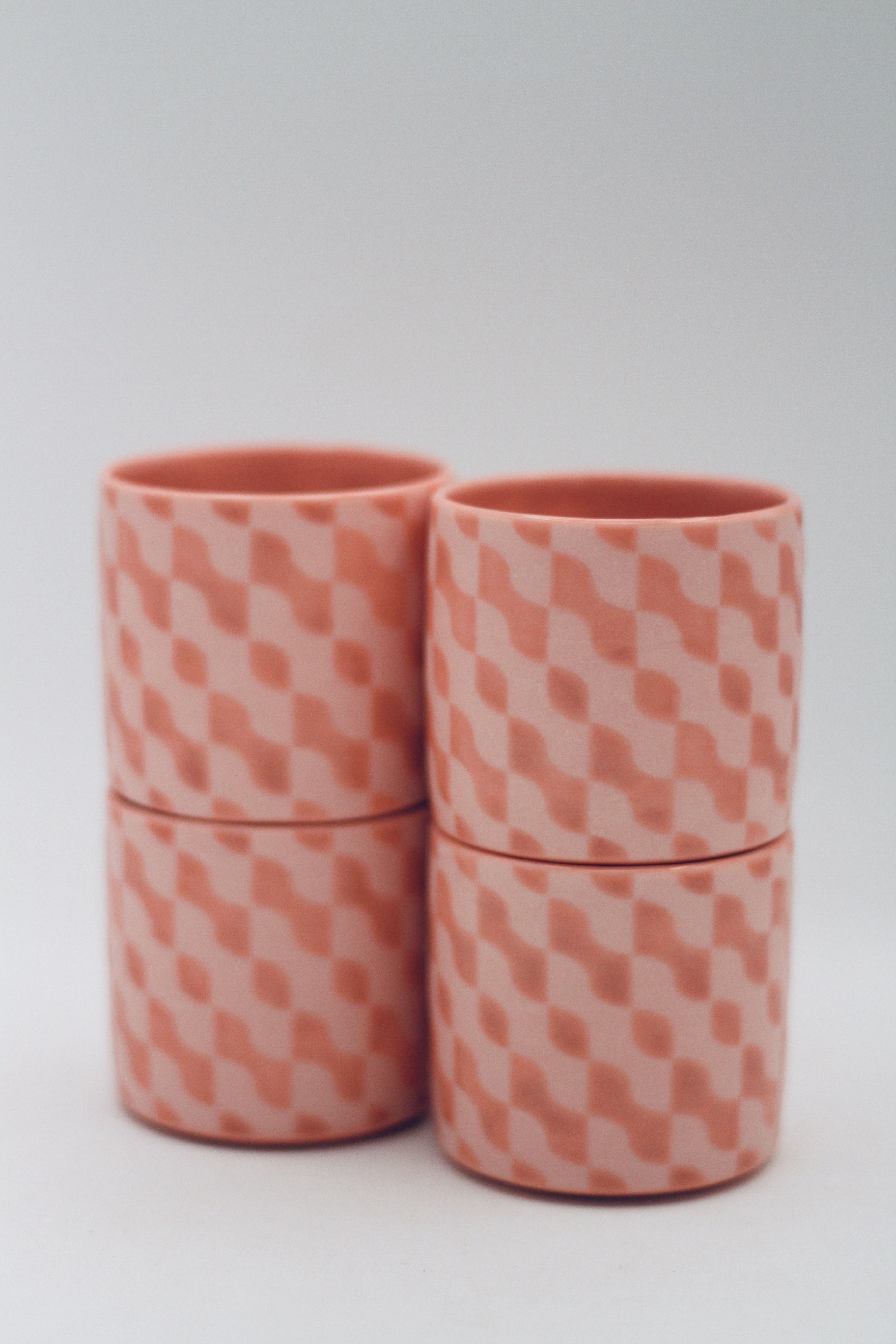 set of 4 identical porcelain lobster-colored tea cups