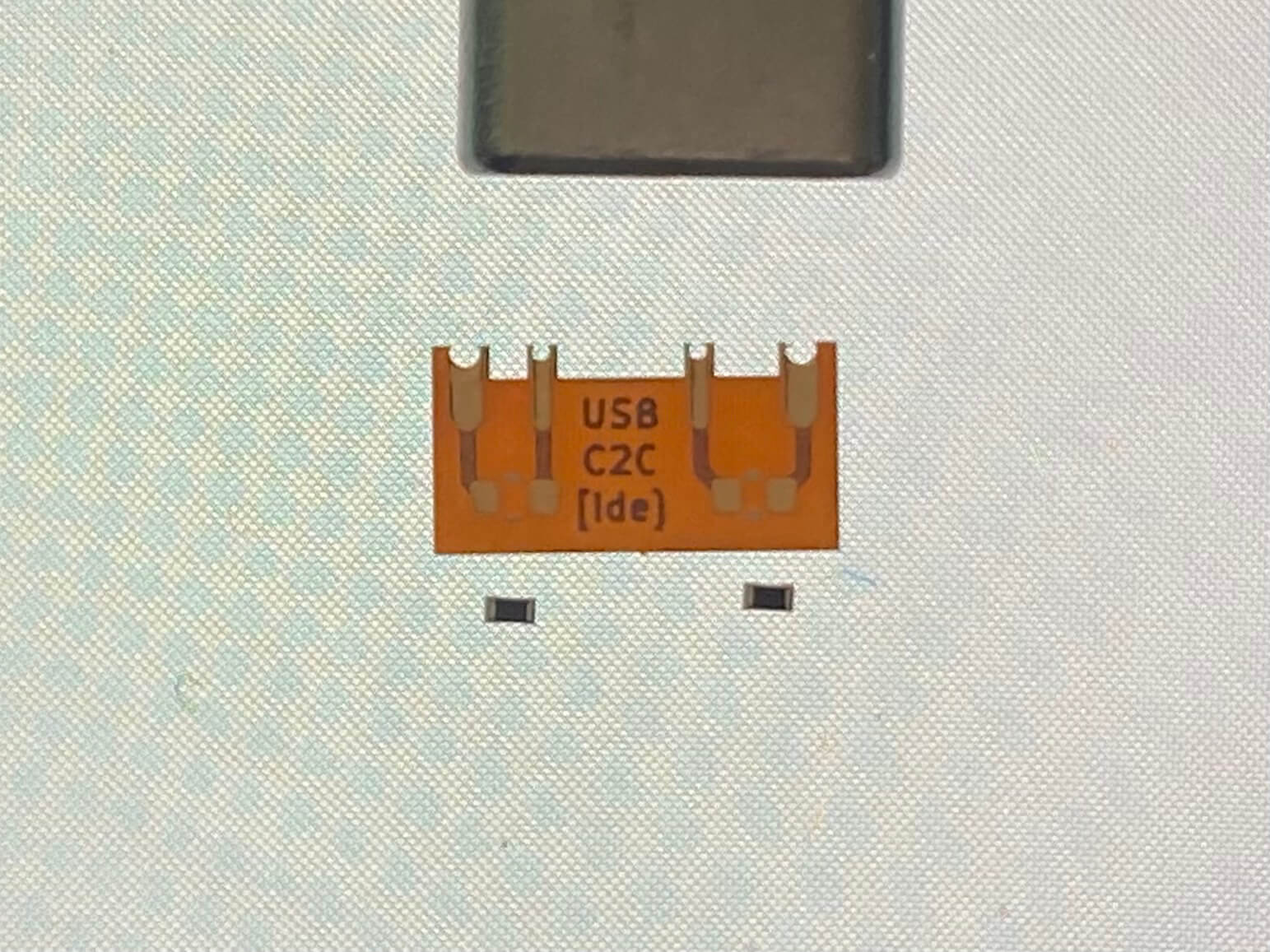 Flex PCB and SMD resistors with a USB-C cable for scale