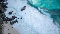 brown_rocks_on_white_sand_beach_4k_5k_hd-3840x2160.jpg