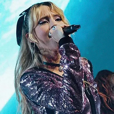 Angele, the Belgian singer, singing into
a microphone