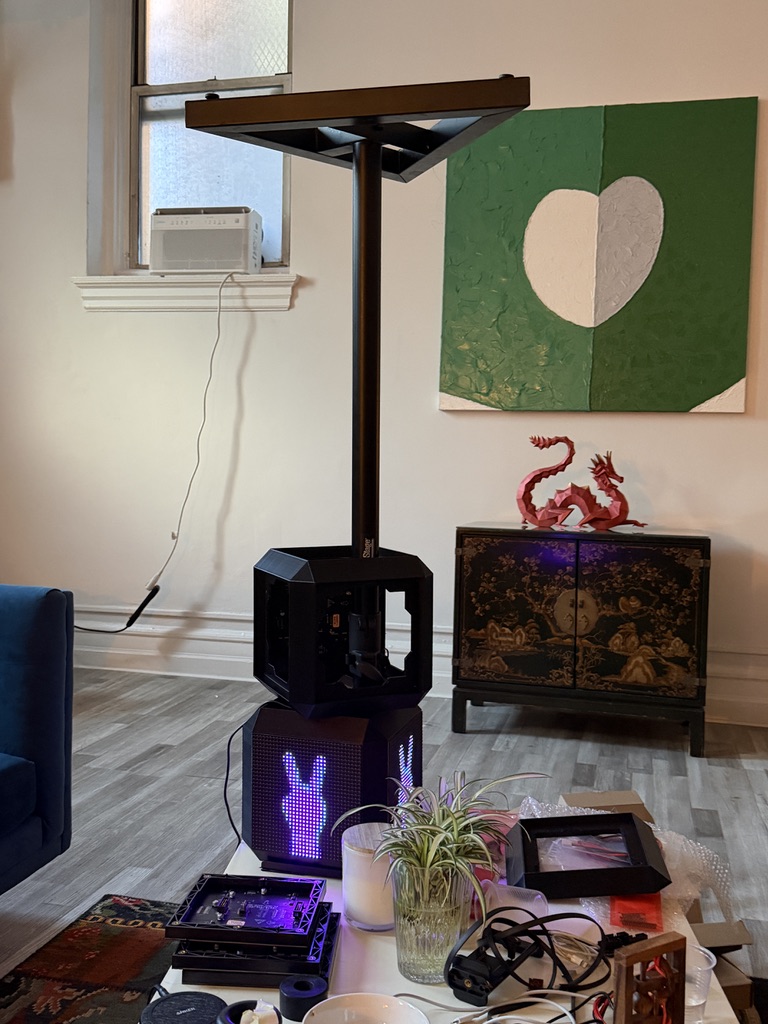 An open cube housing and illuminated cube during assembly in the studio