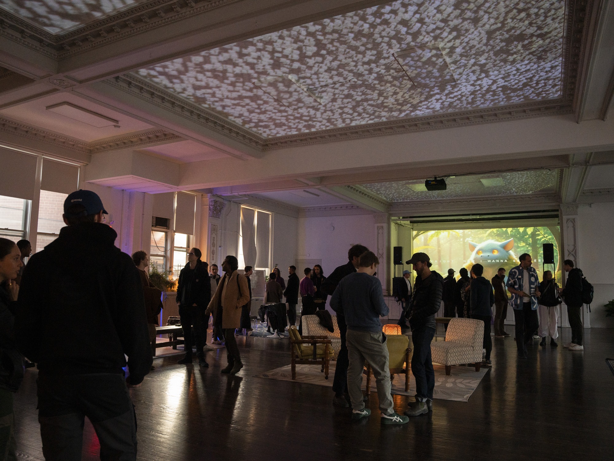 A gathering at School with ceiling projections and an auditorium screen