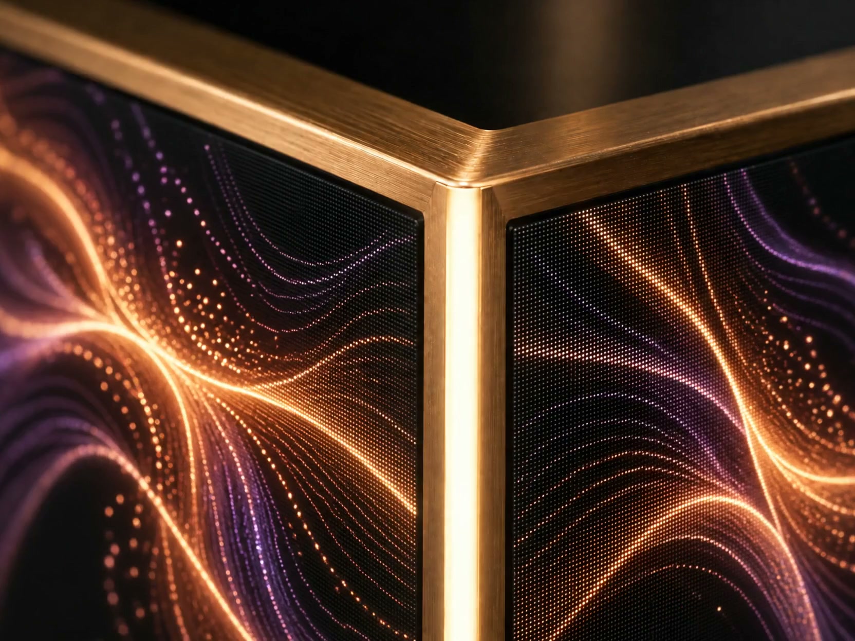 Close-up concept of brushed bronze, a softly illuminated edge and amber-violet artwork across two LED faces.