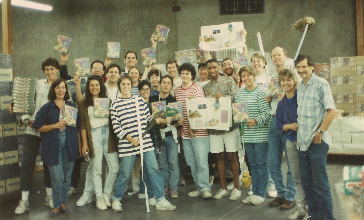 The LucasArts team packing boxes of The Secret of Monkey Island for shipment, c. 1990. Among them: Ron Gilbert, Tim Schafer, Dave Grossman, Steve Purcell, Mark Ferrari, and the rest of the crew who built a genre-defining classic.
